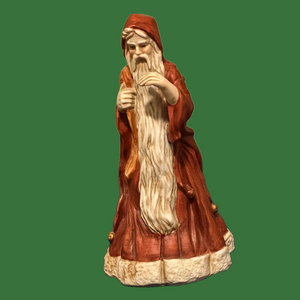 Incredible porcelain Santa carries his pack& wears a brownish robe.